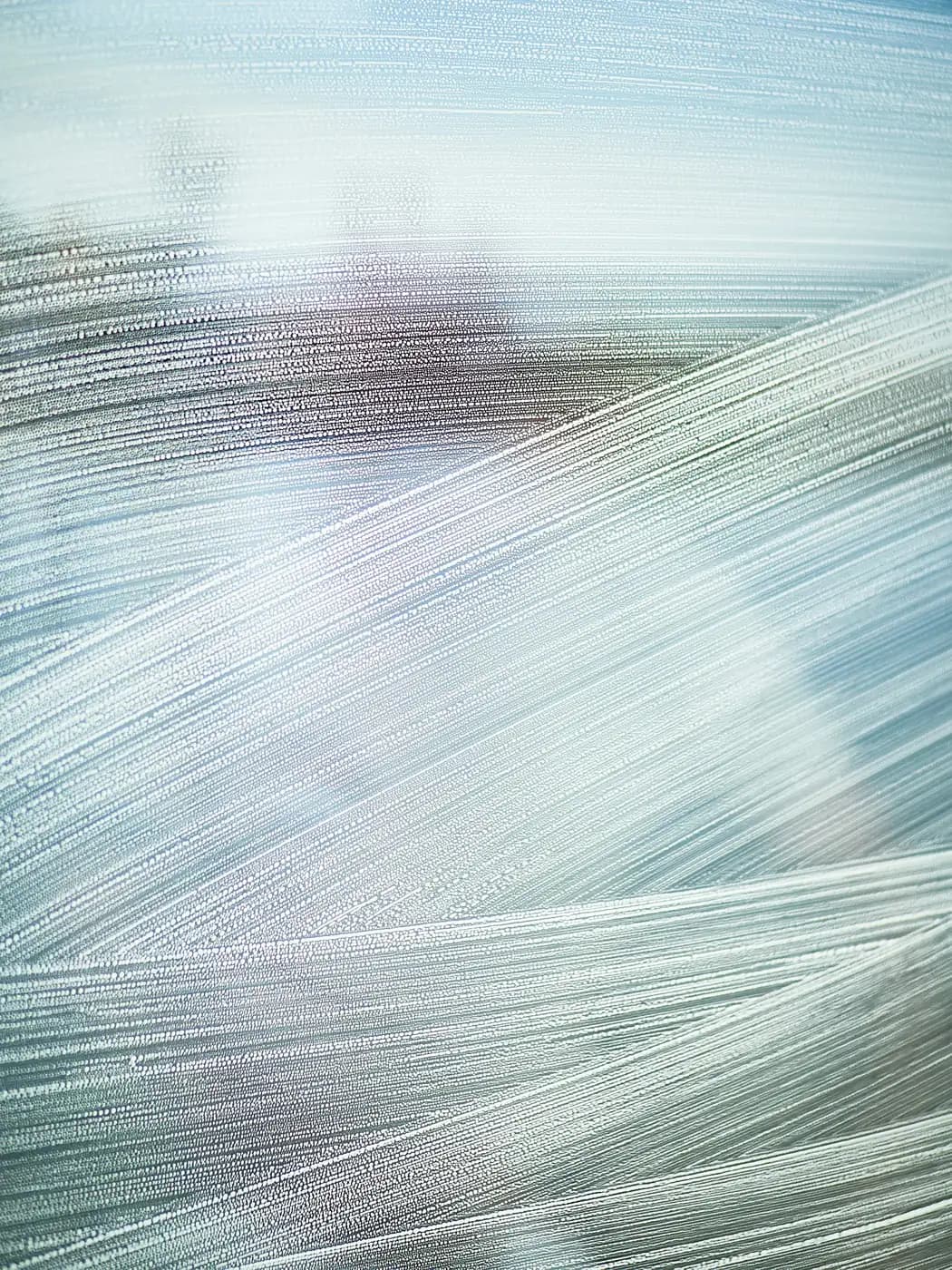 Soap swirls smeared across glass, the light behind it out of focus
