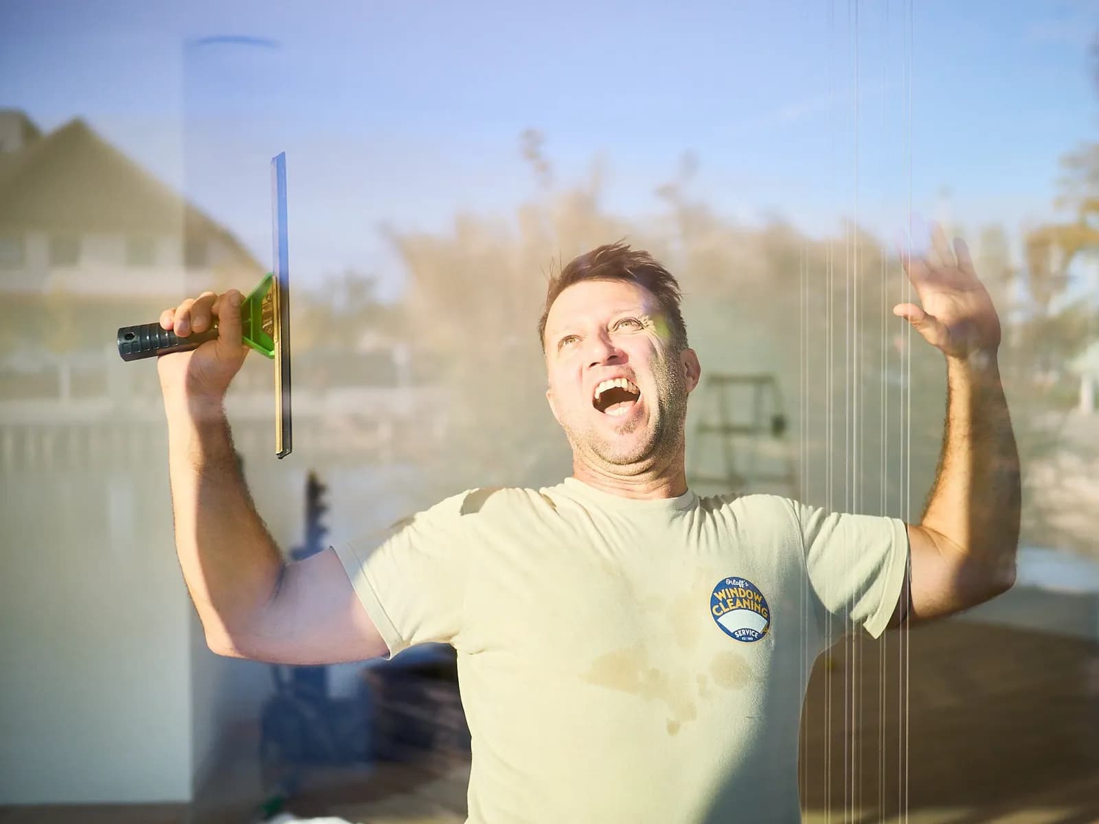 Justin Orloff, arms crossed, standing confident by the water after a day's work